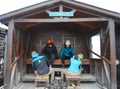 Mountain guides help tourists place crampons before ice trekking on Perito Moreno Glacier