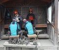 Mountain guides help tourists place crampons before ice trekking on Perito Moreno Glacier