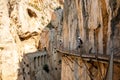 El Chorro, Spain. El Caminito del Rey walkway along the steep walls of a narrow gorge, narrow wooden platforms attached to rocks Royalty Free Stock Photo