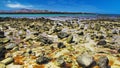 El Cotillo, North Fuerteventura: Many countless stones in water scattered in sand at rocky beach during ebb, turquoise sea lagoon Royalty Free Stock Photo