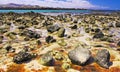 El Cotillo, North Fuerteventura: Many countless stones in water scattered in sand at rocky beach during ebb, turquoise sea lagoon Royalty Free Stock Photo