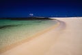 El Cotillo, North Fuerteventura: View over bright white sand beach on turquoise lagoon of beach La Concha against deep blue sky