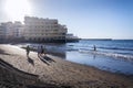 Senior local women walking on Playa El Medano beach during sunrise in El Medano