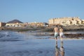 Man and woman strolling on Playa de la Jaquita, El Medano, Tenerife, Canary Islands, Spain
