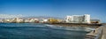 Wide angle panorama View of the volcanic beach towards the resort hotels, restaurants and terraces, in the bohemian village of El Royalty Free Stock Photo