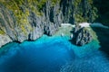 El Nido, Palawan, Philippines. Aerial above view of banca boats surrounded by karst scenery rocks at Secret Lagoon beach