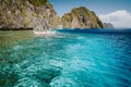 El Nido, Palawan, Philippines. Banca boat in crystal clear ocean water near Matinloc island, highlights of hopping trip on Tour C Royalty Free Stock Photo