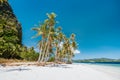 El Nido, Palawan, Philippines. Beautiful Ipil beach with coconut palm trees, sandy beach and blue ocean Royalty Free Stock Photo