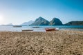 El Nido, Palawan,Philippines. Local fishing boats during low tide at Las Cabanas Beach with amazing mountains in background Royalty Free Stock Photo