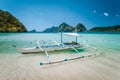 El Nido, Palawan, Philippines. Local tourist banca boat for island hopping trip. Beautiful mountains in background