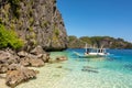 El Nido Palawan Philippines: Tropical landscape with boat, blue and crystal clear sea water, white sand and island Royalty Free Stock Photo