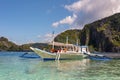 El Nido Palawan Philippines: Tropical landscape with boat, blue and crystal clear sea water, white sand and island Royalty Free Stock Photo