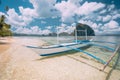 El Nido, Palawan, Philippines. White banca boat on sandy beach with crystal clear water ready for island hopping trip Royalty Free Stock Photo