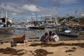 El Nido, Philippines - 22 Nov 2018: filippino children playing on sand beach with fishing boats. Ethnic people poverty