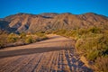 El Oso Road with warm morning light on the mountains in the background