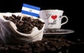 El Salvador flag in a bag with coffee beans isolated on black