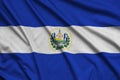 El Salvador flag is depicted on a sports cloth fabric with many folds. Sport team banner