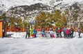 Ski instructor teaching a group of young kids how to ski and get on ski drag lift, Andorra