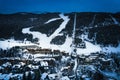 El Tarter village at night with snowy ski slopes cutting through forest in Pyrenees, Andorra Royalty Free Stock Photo