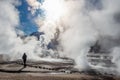 El Tatio geysers, Chile, Silhouette of a woman walking among the steams and fumaroles at sunrise Royalty Free Stock Photo