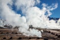 El Tatio geysers in Chile, Silhouettes of tourists among the steams and fumaroles