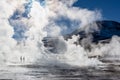 El Tatio geysers in Chile, Silhouettes of tourists among the steams at sunrise Royalty Free Stock Photo