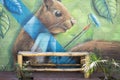 Mural painting in El Tunco with empty bamboo bench. Murals are very popular in El