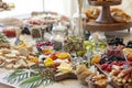 Elaborate charcuterie table set up with meats, bread, cheese, nuts, and fruit