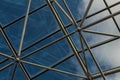 Elaborate steel metal greenhouse structure with diffuse view of deep blue sky with clouds Royalty Free Stock Photo