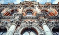 Elaborate stonework depicting classical ornaments, with a central mascaron above a grand arch window. Generate AI