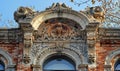 Elaborate stonework depicting classical ornaments, with a central mascaron above a grand arch window. Generate AI