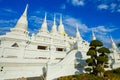 Elaborated white Buddhist Pagoda at Wat Asokaram Temple in Thailand