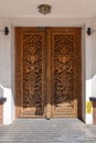 Elaborately carved Asian wooden door on the entrance to a restaurant in Rugby