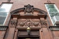 Elaborately carved pediment over an entry door on an old brownstone