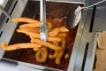 Elaboration of churros in a street stall