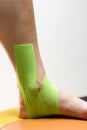 Elastic therapeutic tape on foot