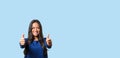 Elated successful young woman giving a double thumbs up Royalty Free Stock Photo