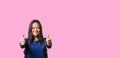 Elated successful young woman giving a double thumbs up Royalty Free Stock Photo