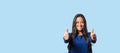 Elated successful young woman giving a double thumbs up Royalty Free Stock Photo