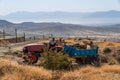 Workers carrying stones via tractor in a hilly area