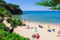 Heavenly beach on the coast of the island of Elba in Italy. Some vacationers sunbathing in an