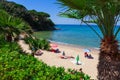 Heavenly beach on the coast of the island of Elba in Italy. Some vacationers sunbathing in an