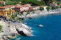 Elba Island, Italy. June 25, 2016: Seashore with beach and rocks and rocky slope of the Island of Elba in Italy. Many people on Royalty Free Stock Photo