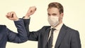 Elbow bumping to fight coronavirus. Lawyer in face mask elbow bump with colleague. Elbow bumping