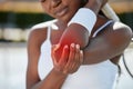 Elbow pain, black woman has fitness injury and tennis athlete outdoor with medical emergency and red overlay. Health