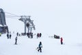 Elbrus, Russian Federation - January 20, 2024: People snowboard and ski during heavy snowfall on Elbrus in winter Royalty Free Stock Photo