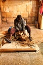 Craftsman carving wood at a market stall