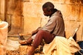 Craftsman carving wood at a market stall