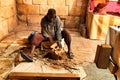 Craftsman carving wood at a market stall