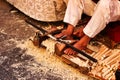 Craftsman carving wood at a market stall